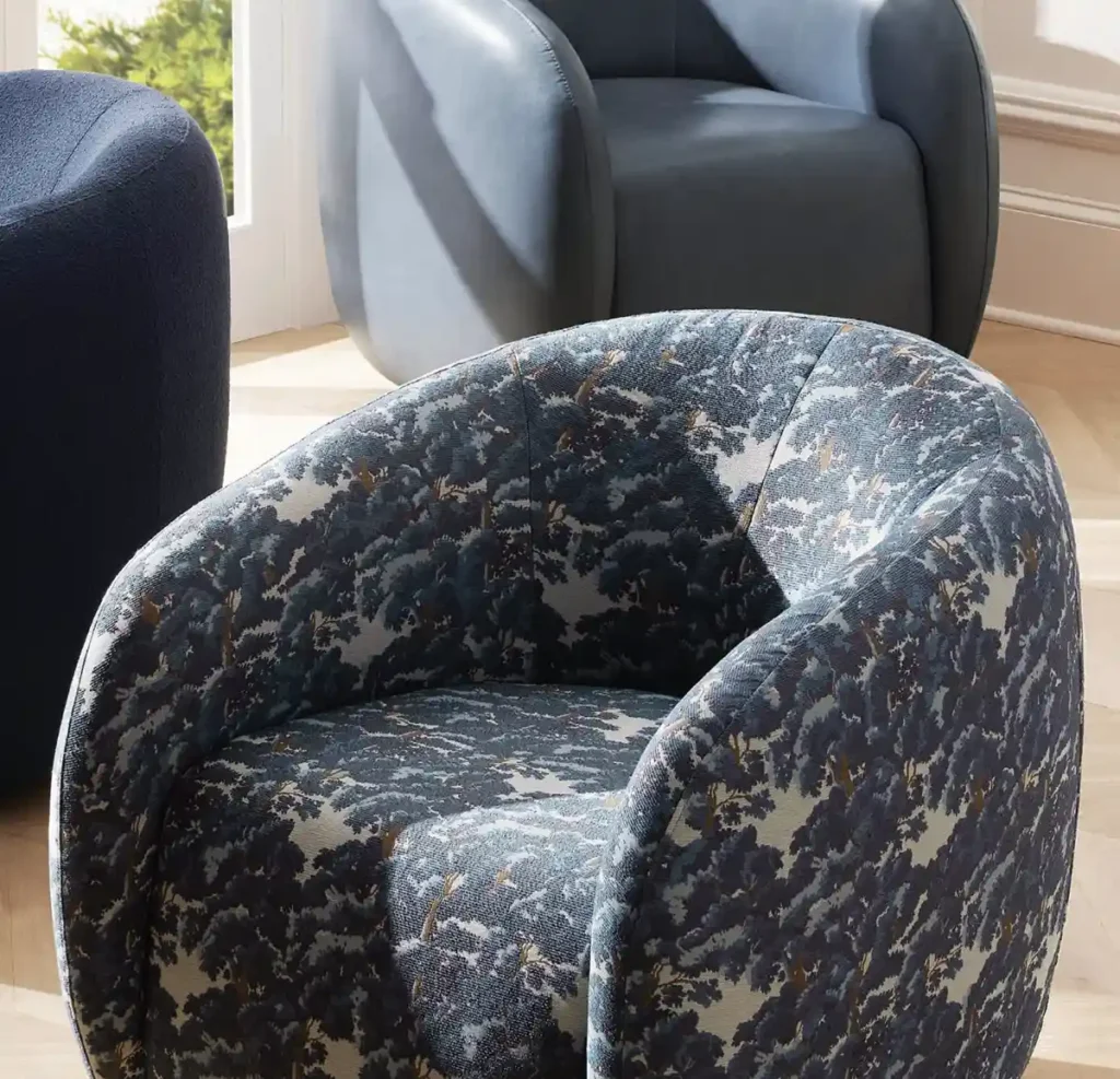 Blue floral fabric upholstered swivel chair from Arhaus