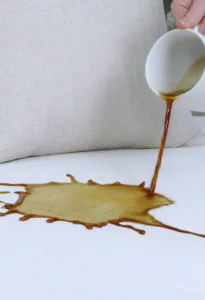 Hot water extraction cleaning for a white couch with a larch coffee stain