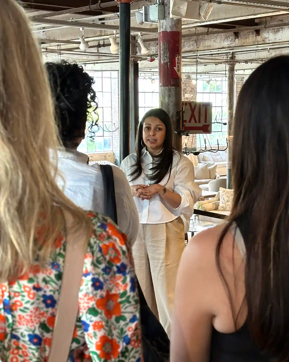 Designers listen to Maurishka Pinedo explain the history of Cisco Home