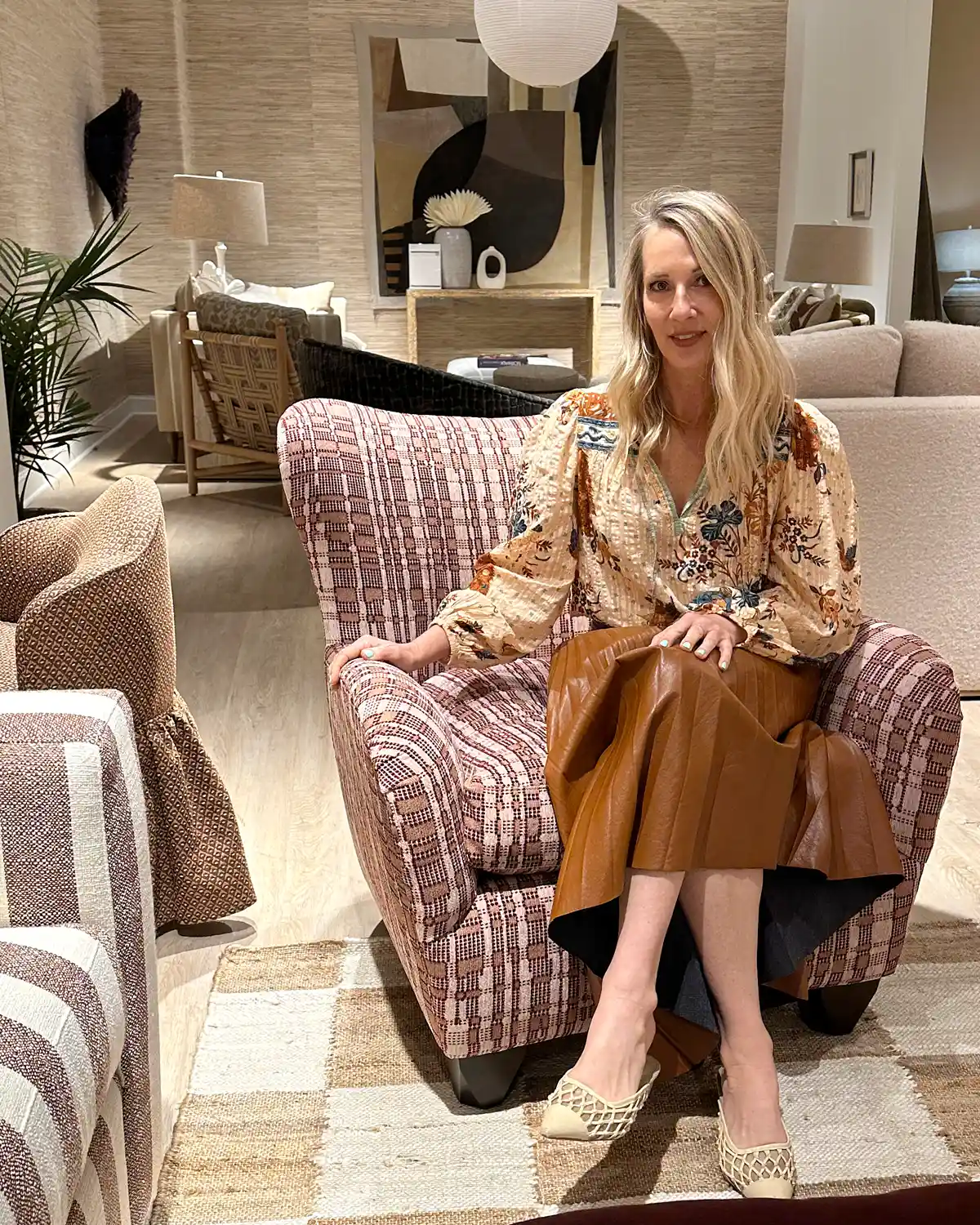 Furniture designer and interior designer Kim Salmela sits in a chair upholstered in our new performance fabric.