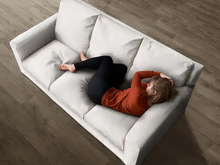 woman napping on white performance fabric sofa