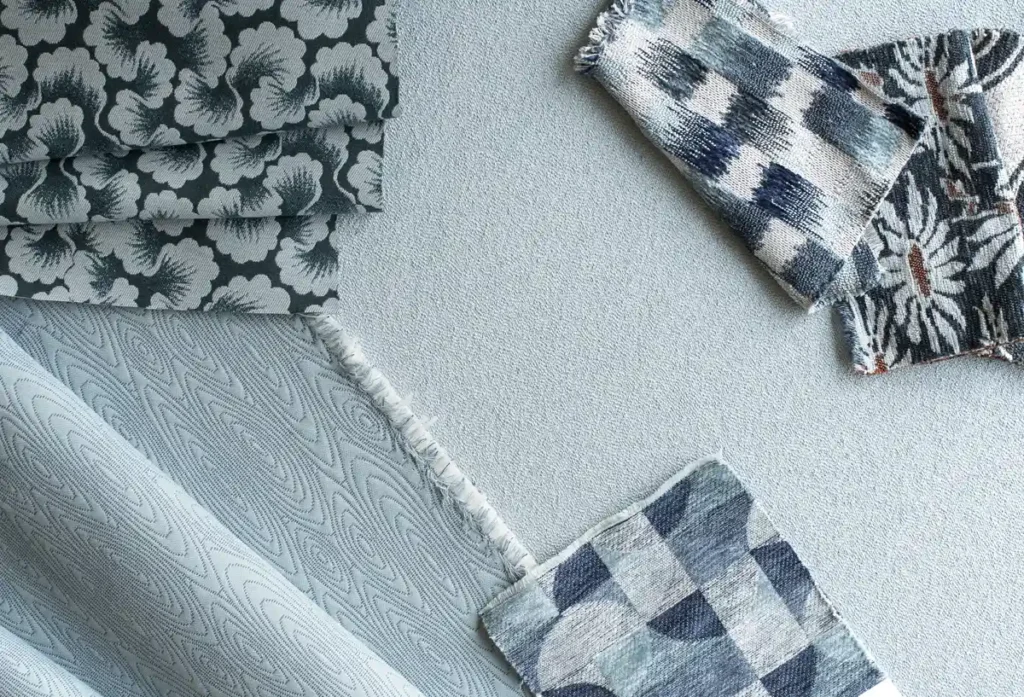 contract fabrics in different shades of blue with abstract floral and checkerboard patterns 