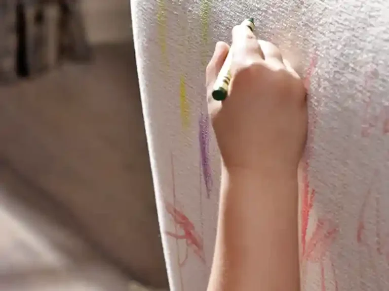 child coloring on white upholstery fabric