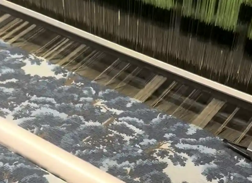 from Kim Salmela latest collection, blue tapesty fabric on warp machine in North Carolina textile mill