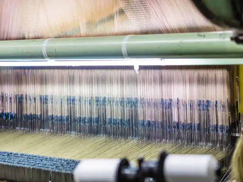 warp machine weaving performance fabric for interior designers at textile mill in America