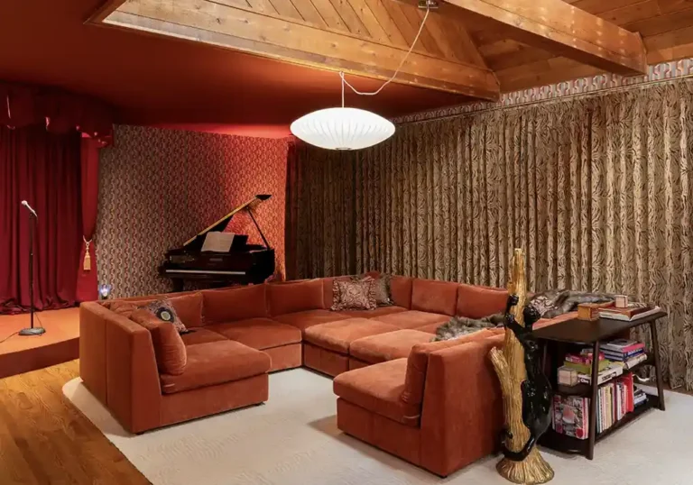 Retro kitsch living room design with animal print curtains and velvet rust sectional