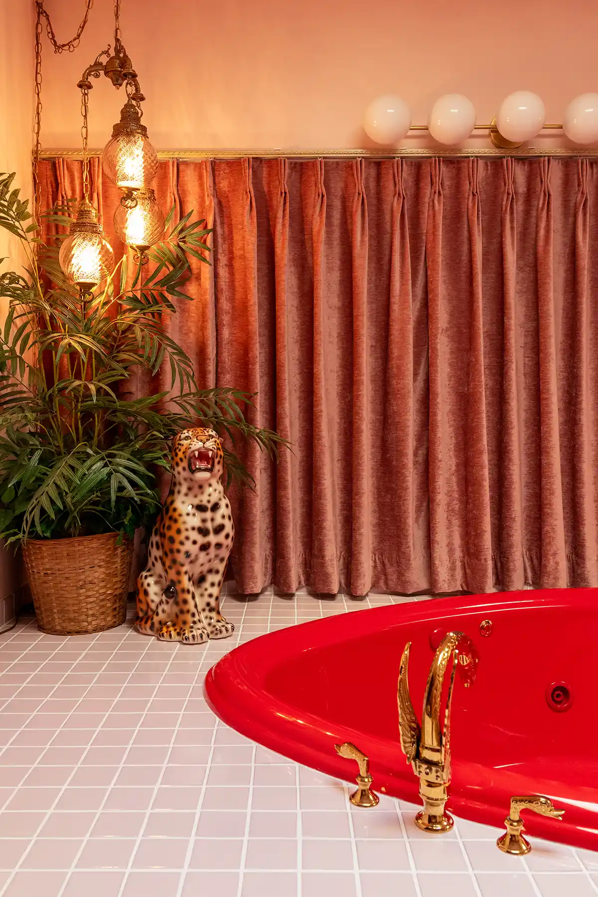 Funky 70s designed bathroom with heart shaped tub with vintage ceramic tiger 