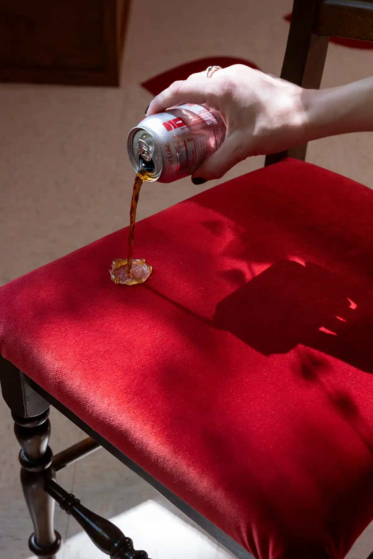 soda spilling onto red performance velvet seat cushions