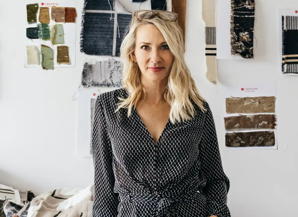 kim salmela standing in front of a fabric wall