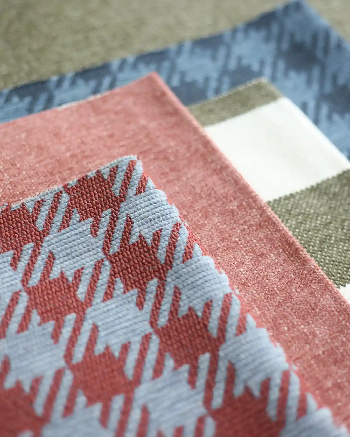 flatlay of mix and match upholstery fabrics in houndstooth pattern, stripes and solids