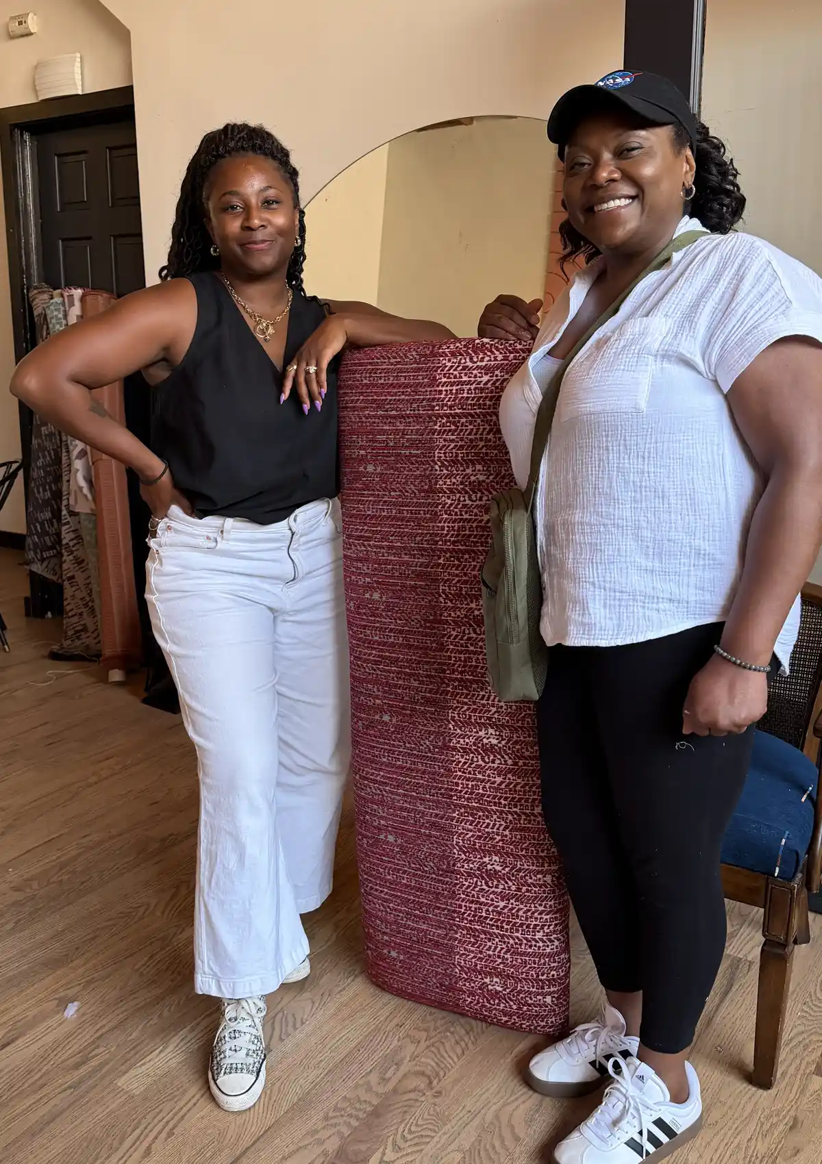 Nicole Crowder and one of her upholstery workshop students pose with finished bench