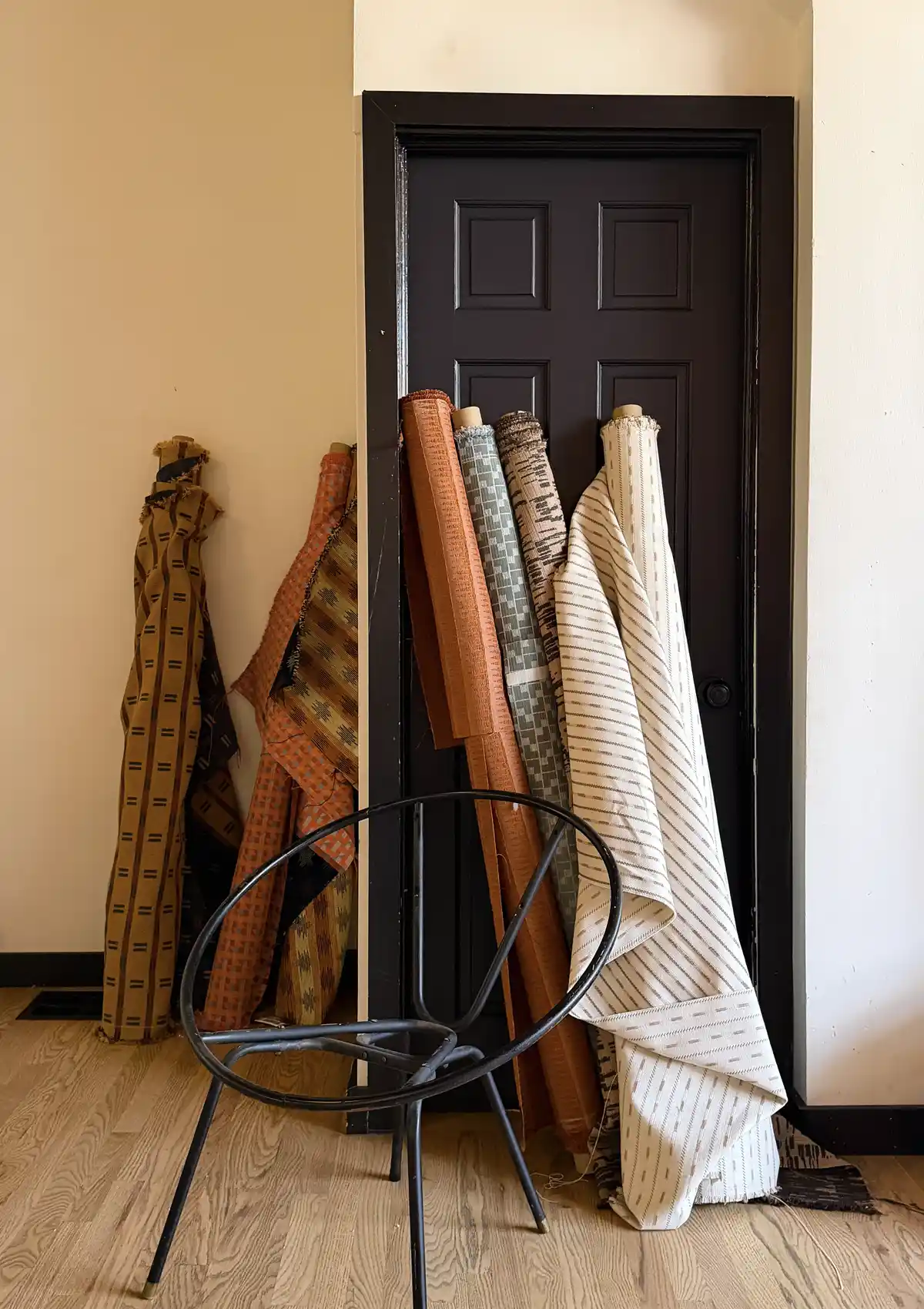 Rolls of upholstery fabric leaning against wall