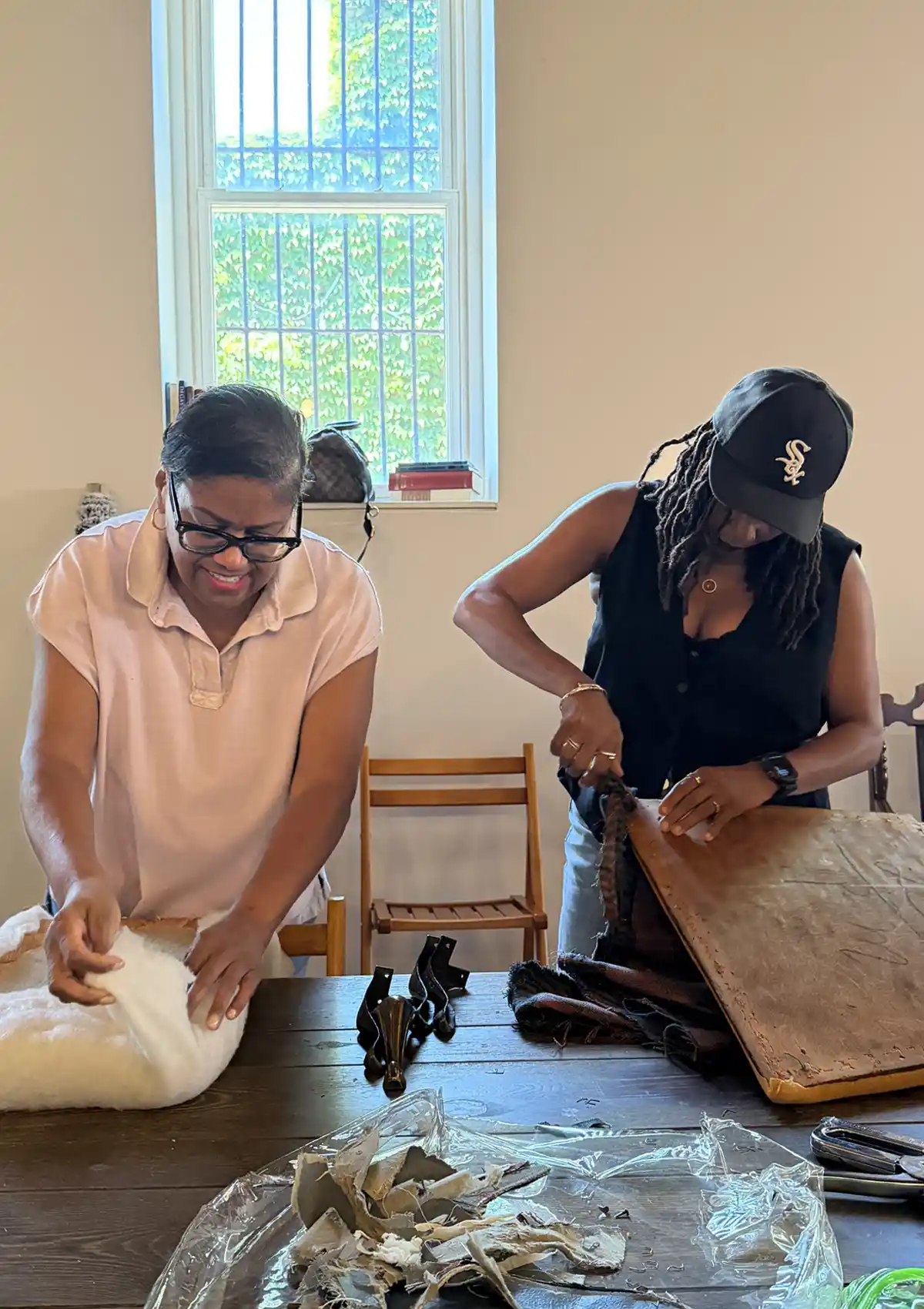Upholstery workshop attendee works on her chair seat